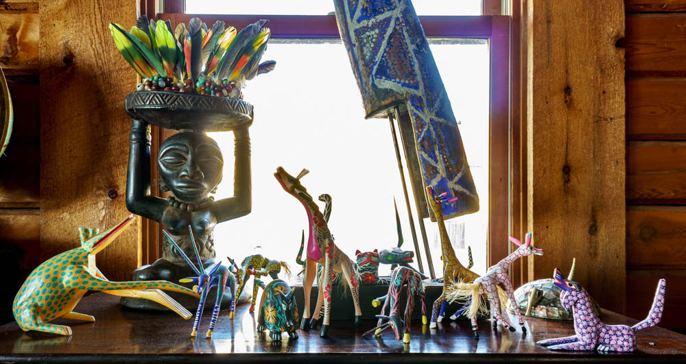 Oaxaca wood carvings, with Luba stool (Africa) and parrot feathers